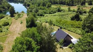 an overhead view of a house on a hill next to a lake at River House Moon in Gospić