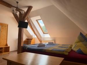 a bedroom with a bed in the attic at Hotel Atawa in Raby