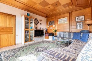 a living room with a couch and a table at Pool Chalet Adonis w/ Panoramic Views - Happy Rentals in Semič