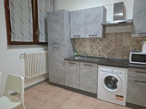a kitchen with a washing machine and a sink at Jessy house in Cantù