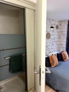 a bedroom with a bed and a brick wall at Etablissement Cloutiers comprenant plusieurs logements de type studio - Hyper Centre Brive in Brive-la-Gaillarde