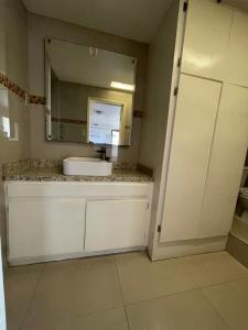 a bathroom with a sink and a mirror at Hotel Regis in Mexicali +23 photos