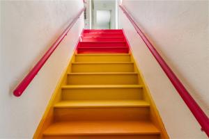 a set of stairs with red and yellow at Sunset Inn and Cabanas in St. Pete Beach
