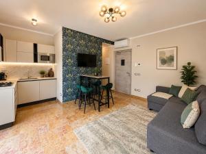 a living room and kitchen with a couch and a table at Galeo Suites in Florence