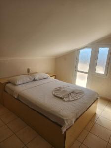 a bedroom with a bed with a towel on it at Everest Apart Hotel in Oludeniz +28 photos