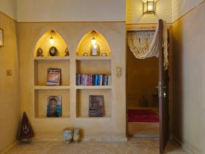 a room with three shelves with books and a hallway at Dar Zaytoun Bhalil in Bhalil