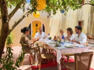 a group of people sitting around a dinner table at Dar Zaytoun Bhalil in Bhalil