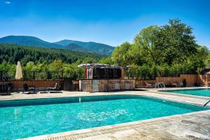 a swimming pool with a view of the mountains at Premier Luxury Mountain Resort in Bansko
