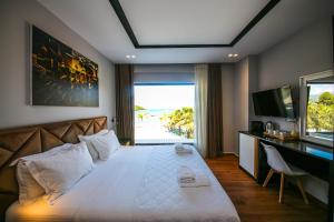 a bedroom with a bed with a view of the beach at King Hotel Ksamil in Ksamil