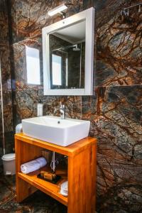 a bathroom with a sink and a mirror at King Hotel Ksamil in Ksamil +113 photos