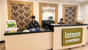 two men sitting at a service counter in an office at The Premier Centauras in Islamabad +67 photos