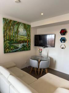 a living room with a couch and a table at Loft Cool Equilibrium in Bogotá