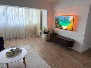 a living room with a couch and a table at Urban Central Hub in Giurgiu