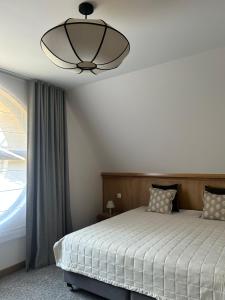 a bedroom with a bed and a ceiling fan at Chaty Gorcovia in Nowy Targ