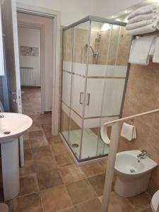 a bathroom with a shower and a toilet and a sink at Domus Cassia in Cascia +29 photos
