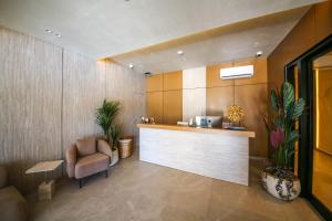 a lobby with a counter and a chair and a bar at Hotel Lake Park Ksamil in Ksamil