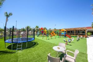 a park with a playground with tables and chairs at Hotel Lake Park Ksamil in Ksamil