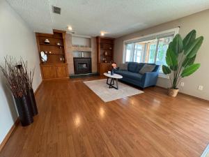 a living room with a blue couch and a table at Metta Stays Edgemont in Calgary