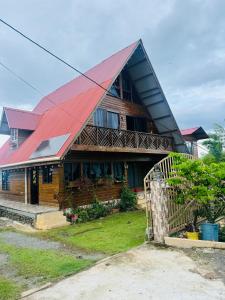 a large house with a red roof at Mi Terraza Hostel in Almirante