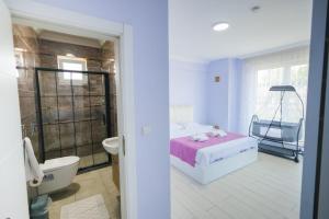 a bedroom with a bed and a bathroom with a tub at Antonelya Home in Sapanca +19 photos