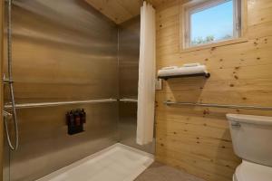 a bathroom with a shower and a toilet at Postcard Cabins Asheboro, Outdoor Collection by Marriott Bonvoy in Asheboro