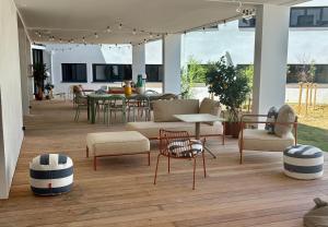 a living room with chairs and a table and chairs at Sweetly La Rochelle in La Rochelle