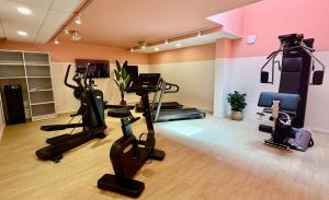 a gym with treadmills and exercise bikes in a room at Sweetly La Rochelle in La Rochelle +17 photos