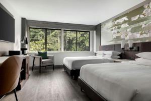a hotel room with two beds and a window at Atlanta Marriott Peachtree Corners in Norcross +48 photos