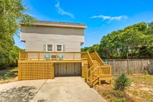 a house with a deck and a garage at 4068 - Family Tradition in Kitty Hawk