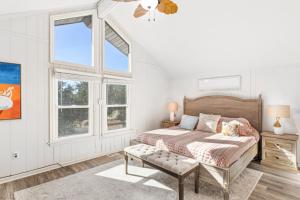 a bedroom with a bed and two windows at 4068 - Family Tradition in Kitty Hawk
