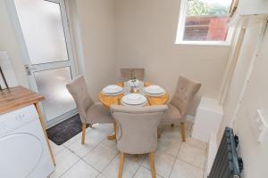a dining room table and chairs in a kitchen at Woodington House in Birmingham