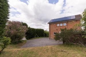 a brick house with solar panels on the roof at Woodington House in Birmingham