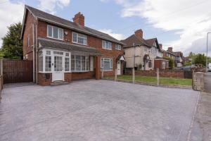 an empty driveway in front of a brick house at Blackthorne House in Walsall