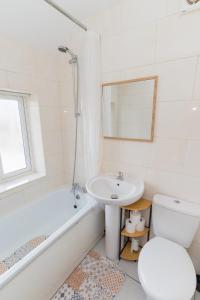a white bathroom with a sink and a toilet at Blackthorne House in Walsall