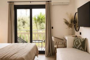 a bedroom with a bed and a view of a balcony at Abelia Boutique Rooms in Tsilivi +12 photos