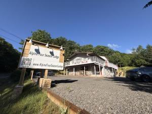 a sign in front of a building with a house at Catskills The Bohemian Dream in Shandaken
