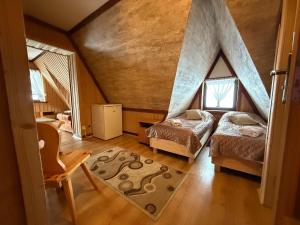 a bedroom with two beds in a attic at Pokoje Janka Gliczarów Górny in Gliczarów +101 photos