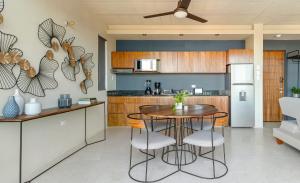 a kitchen with a table and chairs in a kitchen at The Sands Boutique Condos in Playa del Carmen