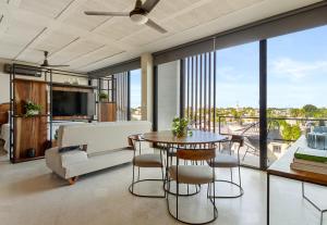 a living room with a couch and a table at The Sands Boutique Condos in Playa del Carmen