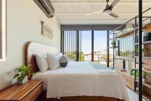 a bedroom with a bed and a balcony at The Sands Boutique Condos in Playa del Carmen +31 photos