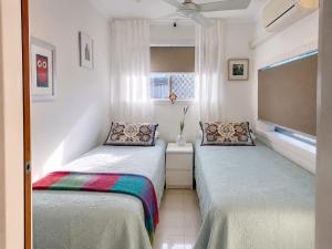 a bedroom with two beds and a window at William's on William - Stylish 2 Bedroom Haven in Ormiston