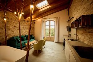 a living room with a green couch and a window at Terra di Gradara in Gradara