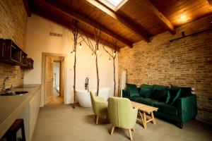 a living room with a green couch and a bath tub at Terra di Gradara in Gradara