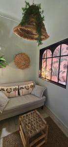 a living room with a couch and two windows at Lola's Sanremo Centro in Sanremo