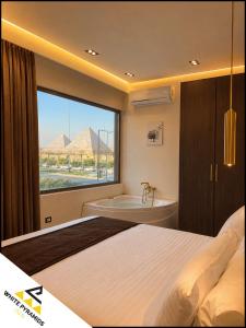 a bedroom with a bed and a tub and a window at New White Pyramids Inn in Cairo
