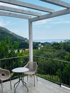 a table and chairs on a balcony with a view at Mostoliva Sea View Studios in Pržno