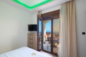 a bedroom with a bed and a room with a balcony at Villa President 4 in Krimovice