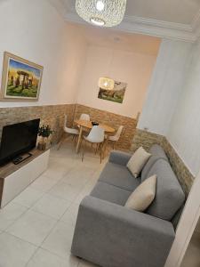 a living room with a couch and a table at Casa A Beira do Mar in O Grove