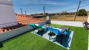 a balcony with two chairs and a table on the grass at Alentejo Colours Cano in Cano