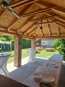 a patio with a table with wine glasses on it at Kucerak u Sremu in Klenak